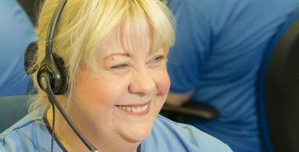 An NHS 24 staff member wearing a telephone headset