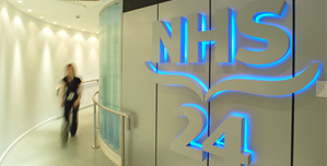 A member of NHS staff walking through a corridor